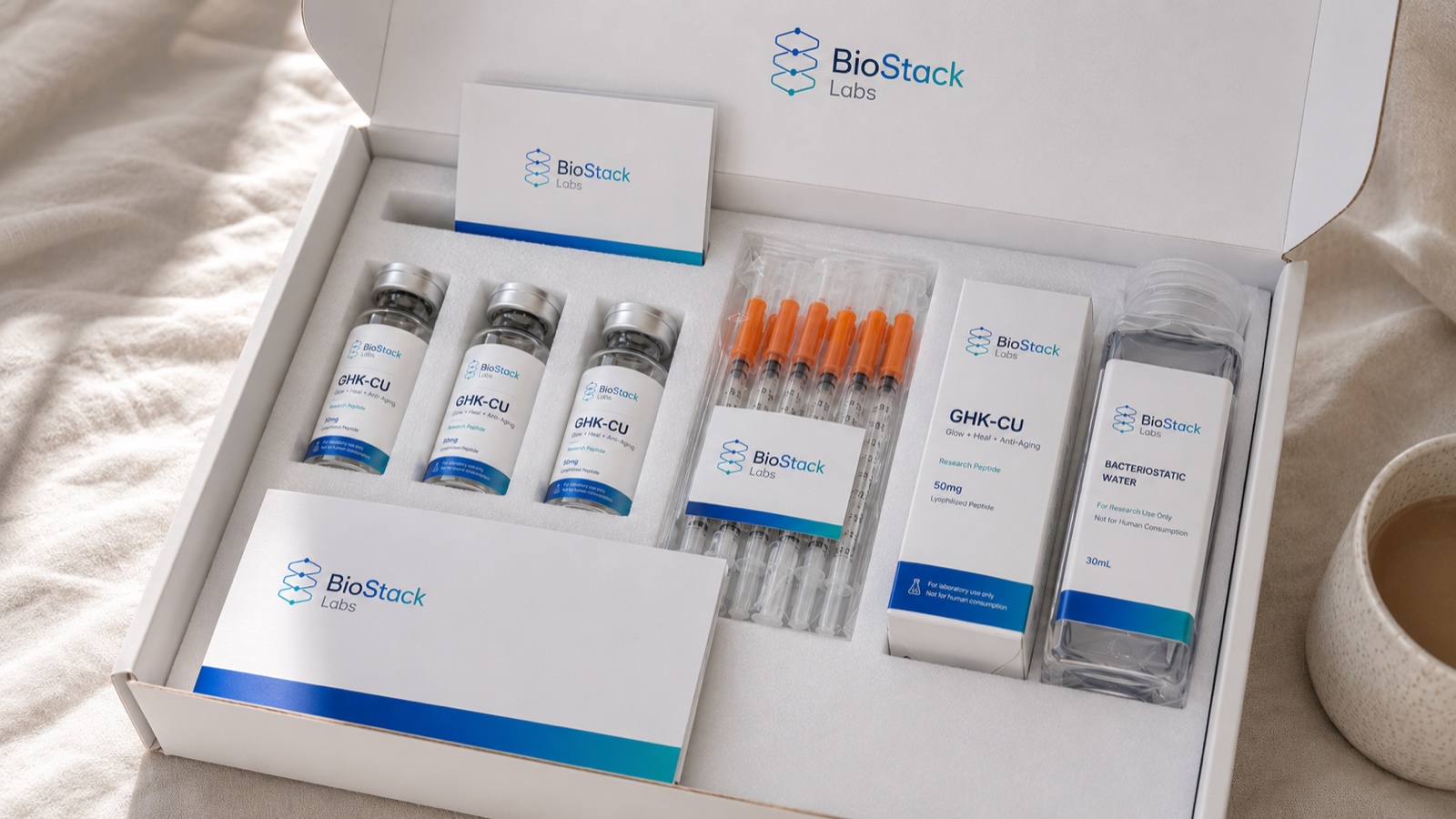 A BioStack Labs research peptide kit — branded GHK-CU vials, sterile syringes, bacteriostatic water and documentation.